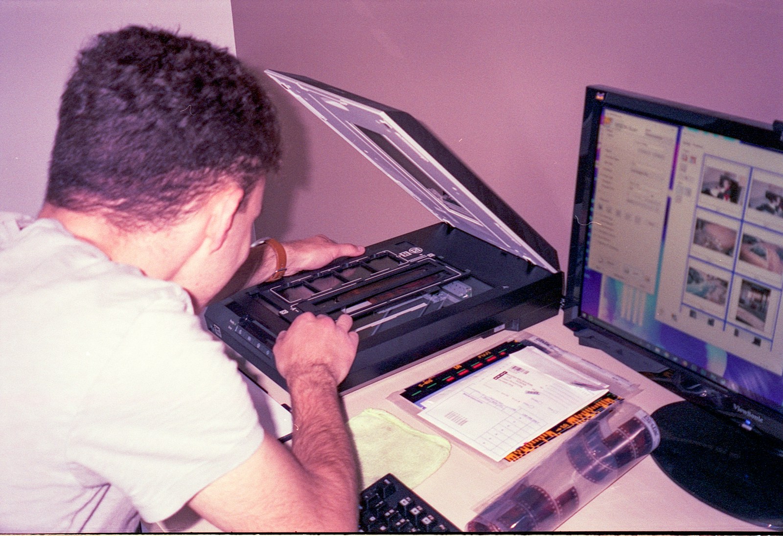 a man sitting at a desk using a laptop computer